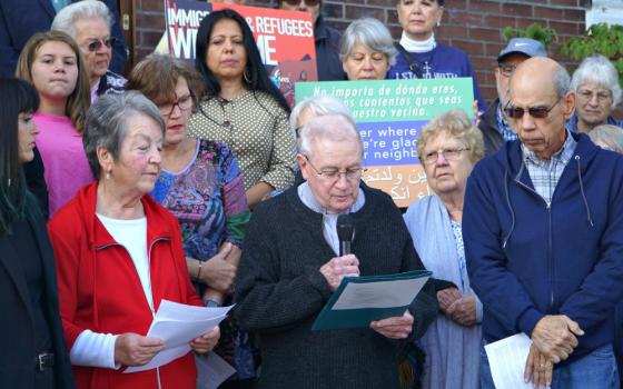 Fr. Jim Flynn, a retired priest of the Archdiocese of Louisville, Kentucky, reads a portion of a statement Oct. 8, 2019, at St. William Church that reaffirmed the parish’s commitment as a sanctuary church. (CNS/The Record/Jessica Able)