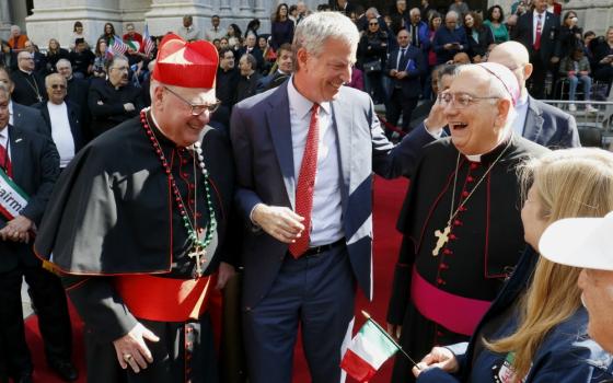 New York City Mayor Bill de Blasio shares a light moment with New York Cardinal Timothy Dolan, left, and Bishop Nicholas DiMarzio of Brooklyn, New York, outside St. Patrick's Cathedral during the Columbus Day Parade in New York City Oct. 14, 2019. (CNS)