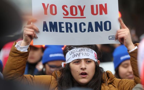 A demonstrator holds a sign outside the U.S. Supreme Court in Washington Nov. 12 as justices hear arguments in a legal challenge to the Trump administration's bid to end the Deferred Action for Childhood Arrivals program. (CNS/Reuters/Jonathan Ernst)