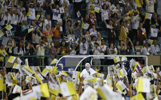 Pope Francis greets the crowd as he arrives to celebrate Mass in National Stadium in Bangkok Nov. 21, 2019. (CNS photo/Paul Haring)