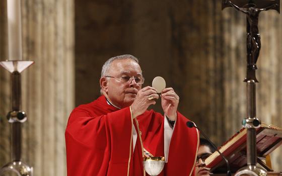 Archbishop Charles Chaput elevates the Eucharist as U.S. bishops from New Jersey and Pennsylvania concelebrate Mass at the Basilica of St. Paul Outside the Walls in Rome Nov. 27, 2019. (CNS/Robert Duncan)