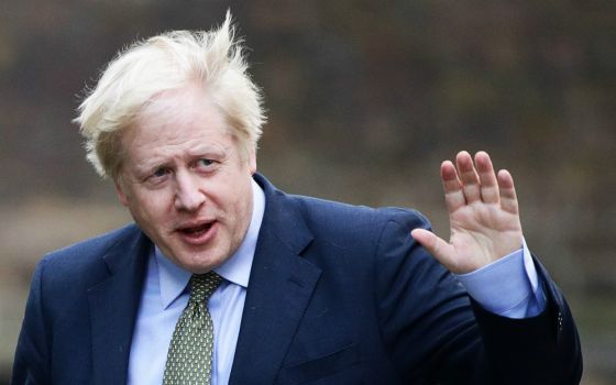 British Prime Minister Boris Johnson waves after meeting with Queen Elizabeth in London to ask for permission to form a government Dec. 13. (CNS/Reuters/Lisi Niesner)