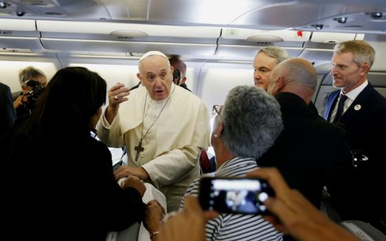 Pope Francis greets journalists aboard his flight from Rome to Maputo, Mozambique, Sept. 4. (CNS/Paul Haring)