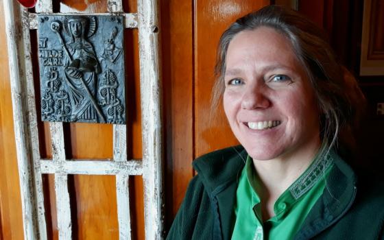 Shanon Sterringer is seen alongside an image of St. Hildegard of Bingen at Hildegard Haus, the church community she leads as a Roman Catholic woman priest in Fairport Harbor, Ohio. (Don Clemmer)