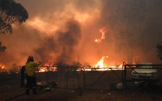 Rural Fire Service crews engage in property protection during wildfires along the Old Hume Highway near the town of Tahmoor, Australia, outside Sydney, Dec. 19, 2019. Wildfires have been burning since August and have destroyed an area comparable to the co