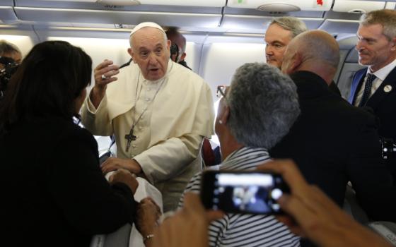 Pope Francis greets journalists aboard his flight from Rome to Maputo, Mozambique, Sept. 4, 2019. (CNS/Paul Haring)