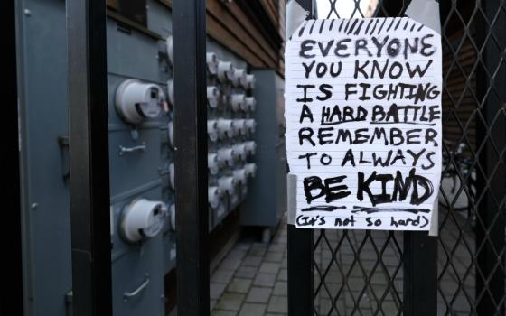 Pedestrians walking along Mississippi Avenue March 18 in Portland, Oregon, could see this handwritten message that acknowledged people are frightened amid the coronavirus pandemic but encouraged them to be kind to one another. (CNS/Reuters)