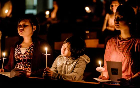 Young people hold candles during the Easter Vigil at the Cathedral of St. Joseph in Hartford, Connecticut, April 4, 2015. (CNS/Bob Mullen)