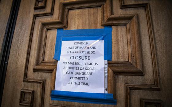 A sign on the door of St. Mary's Catholic Church in Landover Hills, Maryland, alerts the public there will be no Mass. (CNS/Chaz Muth)