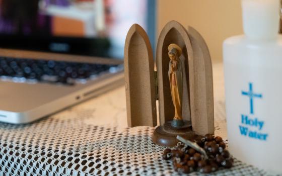 An image of the Blessed Mother adorns a prayer station set up in the home of parishioners of St. Charles Borromeo Catholic Church in Bloomington, Ind., who watched Mass livestreamed from their church March 28, 2020. (CNS photo/Katie Rutter)