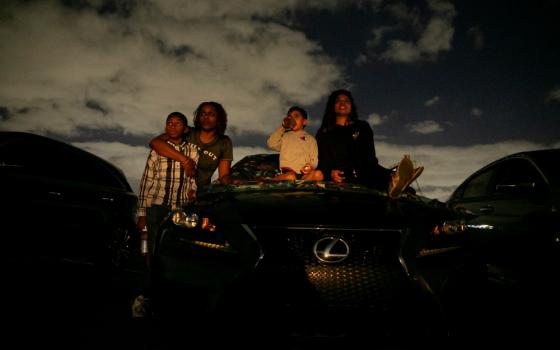 People in Fort Lauderdale, Florida, watch a movie at a drive-in theater during the coronavirus pandemic March 28. (CNS/Reuters/Marco Bello)