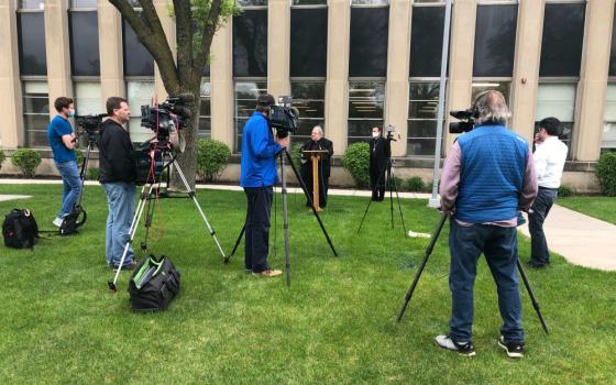 Archbishop Bernard Hebda of St. Paul-Minneapolis speaks to media May 21 outside the Archdiocesan Catholic Center in St. Paul, Minnesota. Standing behind the archbishop is Auxiliary Bishop Andrew Cozzens. (CNS/The Catholic Spirit/Tom Halden)