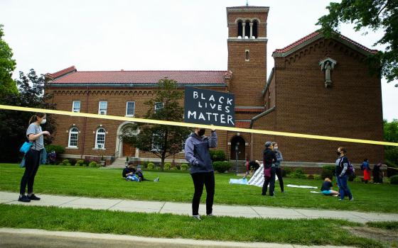 A demonstrator holds a "Black Lives Matter" sign in Washington June 2. (CNS/Tyler Orsburn)