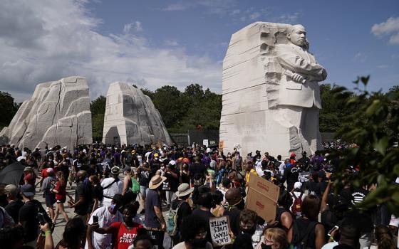 Demonstrators gather next to the Martin Luther King Jr. Memorial for the Aug. 28, 2020, "Get Your Knee Off Our Necks" March on Washington 2020 in support of racial justice. (CNS/Reuters/Erin Scott)