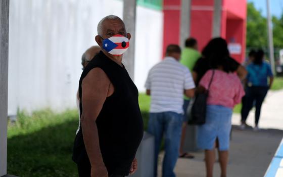 A voter in Loiza, Puerto Rico, waits to cast his ballot Aug. 16, 2020. (CNS/Reuters/Ricardo Arduengo)