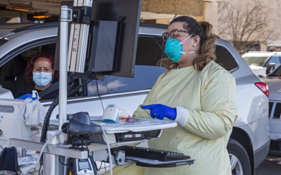 A health care worker in Royal Oak, Michigan, tests for the coronavirus outside Beaumont Hospital March 17, 2020. (CNS/Jim West)