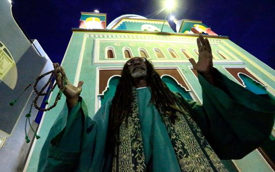 A Muslim man is pictured in a file photo praying outside a mosque in Khartoum, Sudan. (CNS/Reuters/Mohamed Nureldin Abdallah)