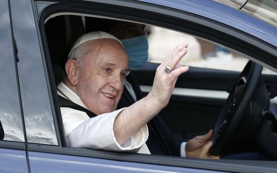 Pope Francis waves from his car after celebrating Mass and signing his new encyclical, "Fratelli Tutti, on Fraternity and Social Friendship" at the Basilica of St. Francis Oct. 3 in Assisi, Italy. (CNS/Paul Haring)