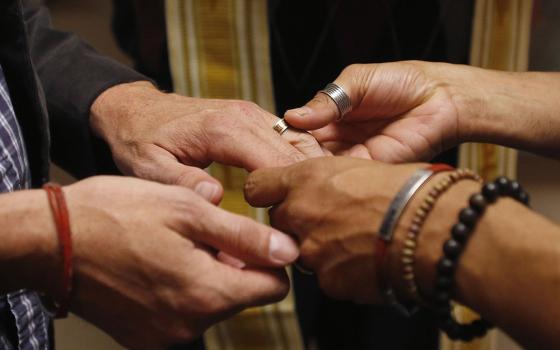 A file photo shows a same-sex couple exchanging rings during a ceremony in Salt Lake City. (CNS/Reuters/Jim Urquhar)