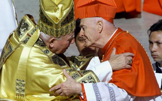 New U.S. Cardinal Theodore McCarrick kisses Pope John Paul II after he received the red biretta during a consistory ceremony in St. Peter's Square at the Vatican Feb. 21, 2001. (CNS/Vincenzo Pinto, Reuters)