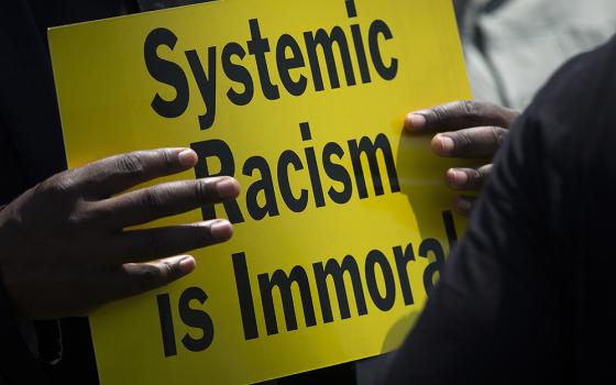 A protester is seen near the Capitol in Washington May 21, 2018, during an anti-racism demonstration. In remarks Nov. 16, during the U.S. bishops' virtual fall meeting, Deborah Amato, National Advisory Council chair, urged the bishops to continue to look 