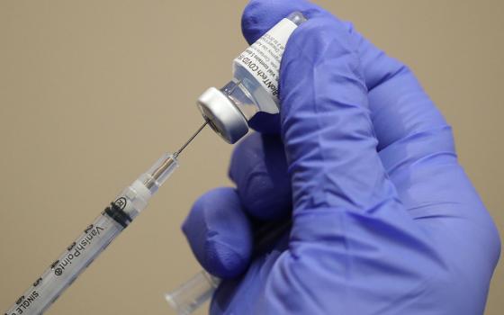 A health care worker at Dignity Health Glendale Memorial Hospital and Health Center in Glendale, California, draws the COVID-19 vaccine from a vial Dec. 17, 2020. (CNS/Reuters/Lucy Nicholson)