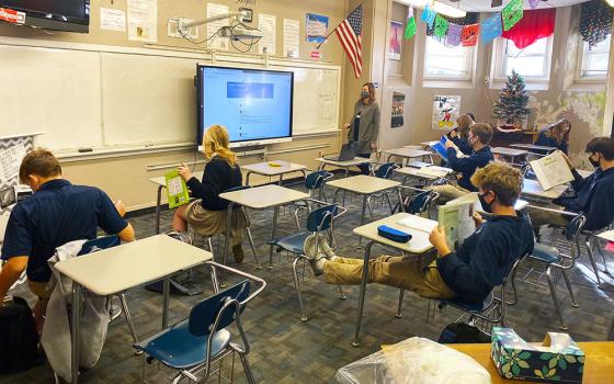 Teacher Melissa Pinkney instructs students during a Spanish class at Thomas More Prep-Marian Jr./Sr. High School in Hays, Kansas, Dec. 3, 2020. The school was in a hybrid model, with half of the students in class and the other half connecting virtually.