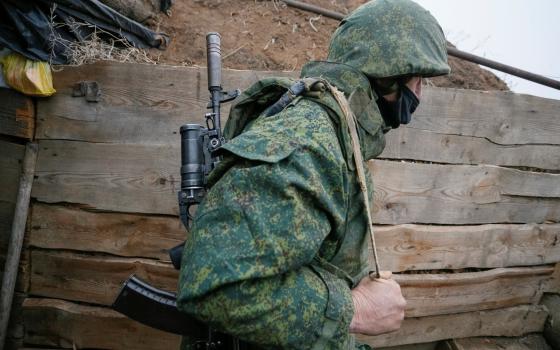 A militant of the separatist Donetsk People's Republic is seen at frontline positions located on the troops contact line with Ukrainian forces near the Ukrainian village of Leninsko Dec. 18, 2020.(CNS photo/Alexander Ermochenko, Reuters)