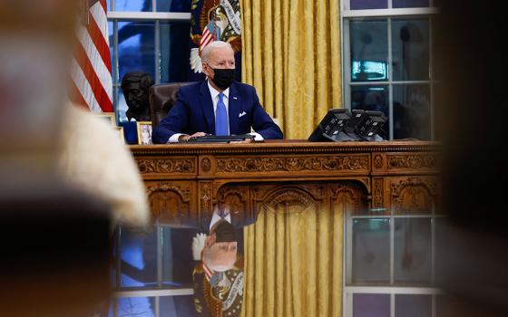 President Joe Biden signs executive orders at the White House Feb. 2 in Washington. (CNS/Tom Brenner, Reuters)