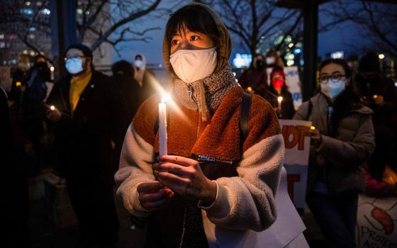 People in Philadelphia attend a vigil in solidarity with the Asian American community March 17. (CNS/Reuters/Rachel Wisniewski)