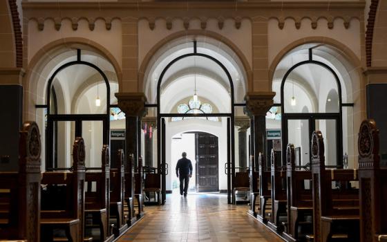 A man leaves an empty church in Bonn, Germany, June 12, 2020. (CNS/KNA/Harald Oppitz)