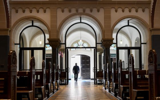 A man leaves an empty church in Bonn, Germany, June 12, 2020. (CNS/KNA/Harald Oppitz)