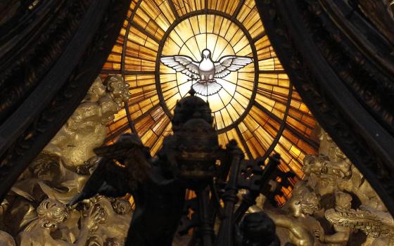 The Holy Spirit window is seen through the baldacchino in St. Peter's Basilica at the Vatican. (CNS/Paul Haring)