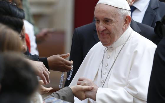 Pope Francis greets people during his general audience June 9 in the San Damaso Courtyard of the Apostolic Palace at the Vatican. (CNS/Paul Haring)