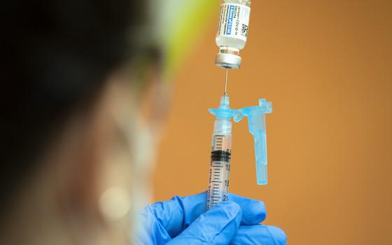 A health care worker at Catholic Charities in Washington prepares to administer the Johnson & Johnson COVID-19 vaccine May 18. (CNS/Tyler Orsburn)