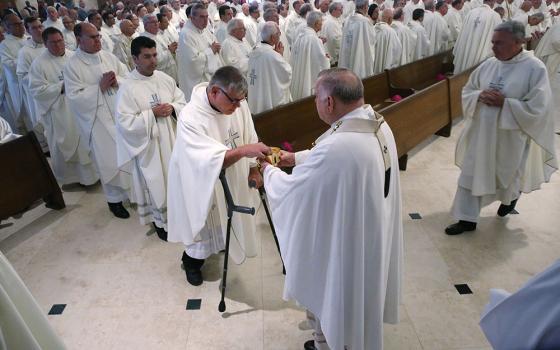 Miami Archbishop Thomas Wenski distributes Communion during Mass at St. Pius X Catholic Church during the U.S. Conference of Catholic Bishops' 2018 spring assembly in Fort Lauderdale, Florida. (CNS/Bob Roller)