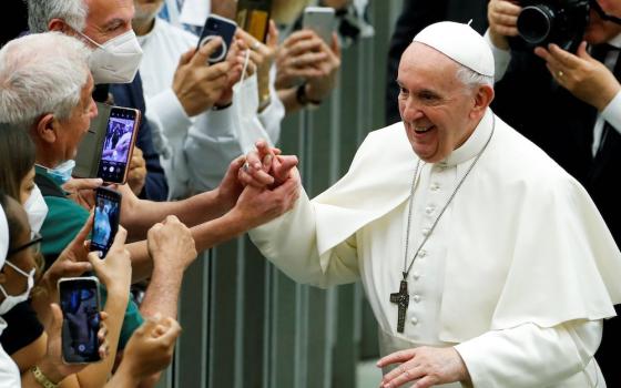 Pope Francis greets people during an event marking the 50th anniversary of the founding of Caritas Italy, at the Vatican June 26. (CNS/Reuters/Remo Casilli)