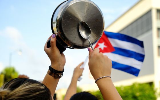 A demonstrator in the Little Havana neighborhood of Miami bangs on a pot July 12 as people rally in solidarity with protesters in Cuba. (CNS/Reuters/Maria Alejandra Cardona)