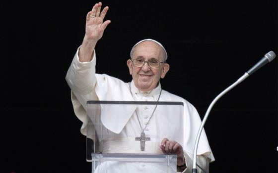 Pope Francis greets the crowd as he leads the Angelus from the window of his studio overlooking St. Peter's Square at the Vatican July 25. (CNS/Vatican Media)