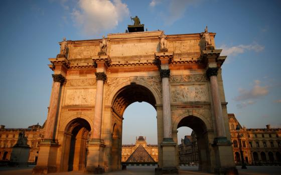 The sun illuminates Paris' famed Arc de Triomphe April 19, 2021. Bishop Nunzio Galantino, president of the Administration of the Patrimony of the Holy See, said the Vatican's purchase of a property near the Arc in 2017 was made "to increase income for the