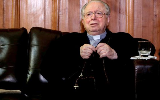 Chilean Fernando Karadima, the defrocked priest at the heart of a sexual abuse case that rocked Chile's Catholic Church, died of natural causes July 25, 2021. He was 90. He is pictured with a rosary inside the Supreme Court building in Santiago Nov. 11, 2