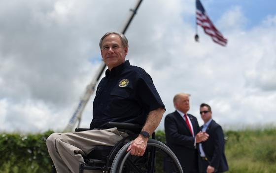 Texas Gov. Greg Abbott exits the stage with former President Donald Trump after a visit to an unfinished section of the wall along the U.S.-Mexico border in Pharr, Texas, June 30. (CNS/Reuters/Callaghan O'Hare)