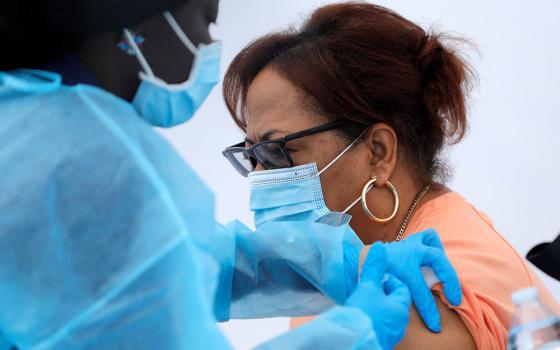 A local resident receives a dose of the Pfizer-BioNTech COVID-19 vaccine during a vaccination event for adolescents and adults outside the Bronx Writing Academy school in New York City June 4. (CNS/Reuters/Mike Segar)