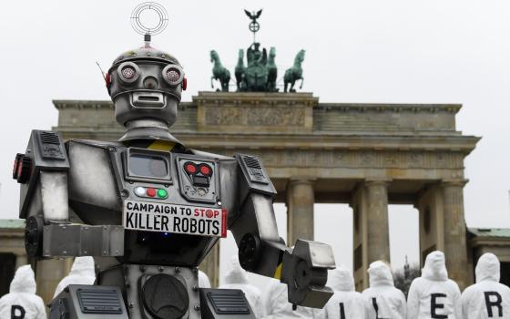 Activists from the Campaign to Stop Killer Robots, a coalition of nongovernmental organizations opposing lethal autonomous weapons, protest at the Brandenburg Gate in Berlin March, 21, 2019. (CNS photo/Annegret Hilse, Reuters)