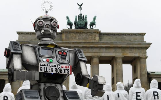 Activists from the Campaign to Stop Killer Robots, a coalition of nongovernmental organizations opposing lethal autonomous weapons, protest at the Brandenburg Gate in Berlin March, 21, 2019. (CNS photo/Annegret Hilse, Reuters)