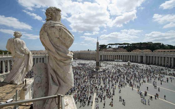 The crowd watches as Pope Francis leads the Angelus message from the window of his studio overlooking St. Peter's Square at the Vatican Aug. 8. In his Angelus message, the pope said Jesus is the "essential bread of life."