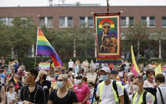 Activists carrying a rainbow flag and a banner with an image of Mary and the Christ Child attend the second "Marzahn Pride" march in Berlin July 17. (CNS/Reuters/Axel Schmidt)