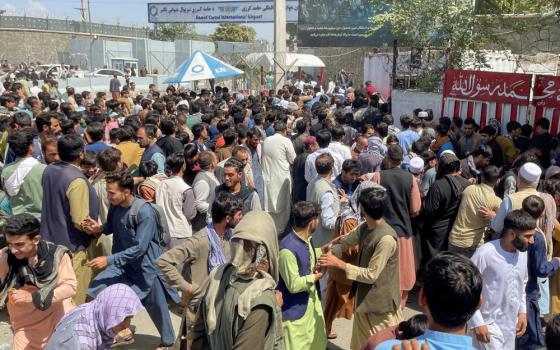 People try to get into Hamid Karzai International Airport Aug. 16 in Kabul, Afghanistan. (CNS/Reuters)