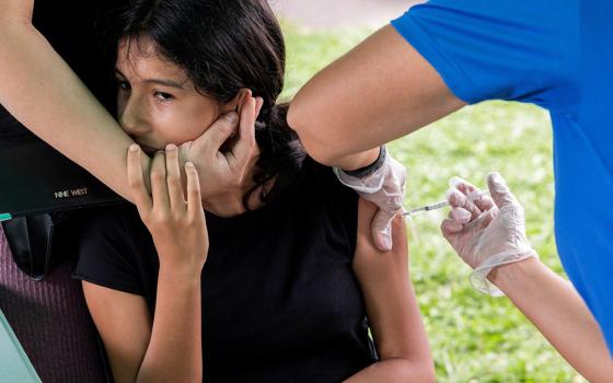 A young person in Bensalem, Pennsylvania, receives the coronavirus vaccine Aug. 22, during an outreach campaign for the Latino community. (CNS/Reuters/Rachel Wisniewski)