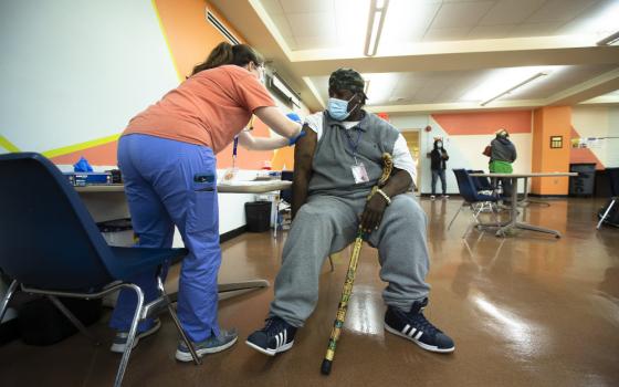 A man at Catholic Charities in the Brookland neighborhood of Washington receives the Johnson & Johnson COVID-19 vaccine May 18 at a pop-up clinic. (CNS/Tyler Orsburn)